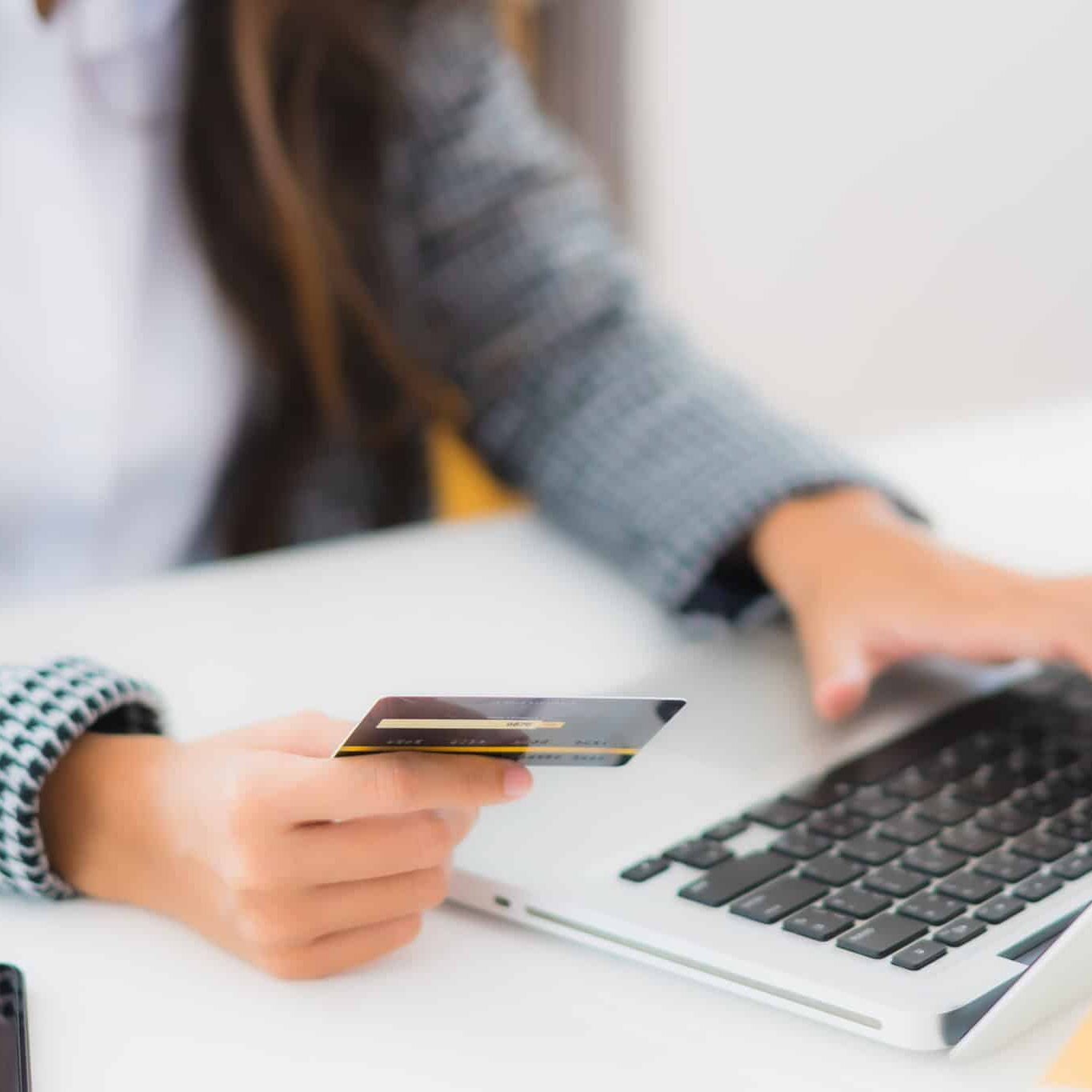 Portrait beautiful young asian woman use credit card with laptop for online shopping item